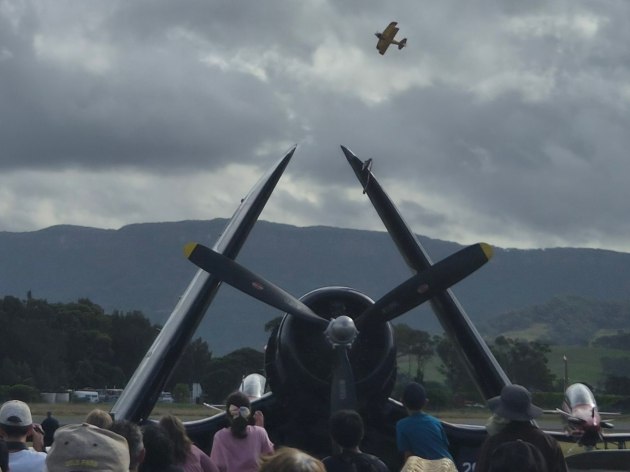 Paul Bennet Airshows display team perform above a Grumman Avenger