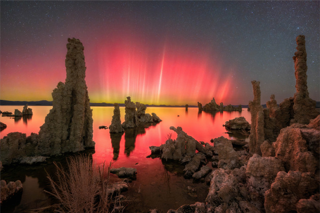 Aurorae, Highly commended, Aurora Over Mono Lake: A Rare Dance of Light © Dan Zafra (Spain).
This photograph captures the rare occurrence of Northern Lights in California. Vibrant ribbons of magenta and green light up the sky, reflecting in the still waters among the rock formations.