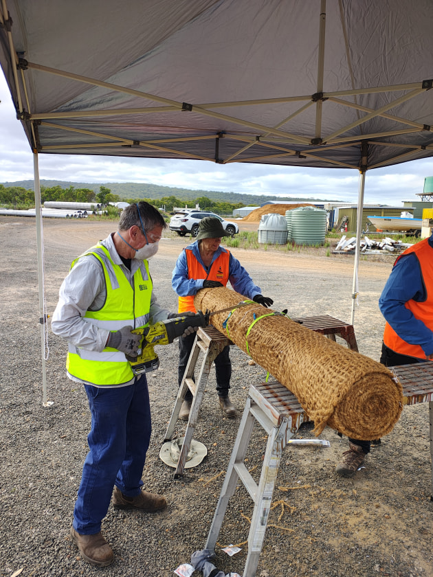 Bibbulmin Track volunteers cutting coir rolls to size