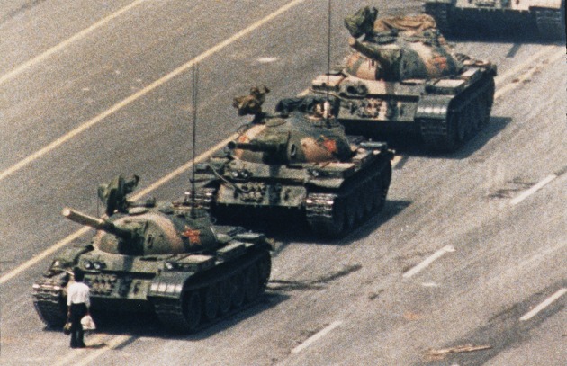 Charlie Cole, Newsweek. "A demonstrator confronts a line of People's Liberation Army tanks on Chang'an Avenue, Beijing, China, during protests for democratic reform on Tiananmen Square, on 5 June 1989. 
Tiananmen Square had been the site of non-violent pro-democracy protests for weeks when the military moved in and opened fire on 4 June. Although there has been no publicly released record of deaths, witnesses estimated up to several thousand fatalities. This photograph, along with other images of the scene, became an international symbol for peaceful resistance. There is no reliable information about what happened to the unidentified demonstrator and the Tank Man pictures remain banned in China."