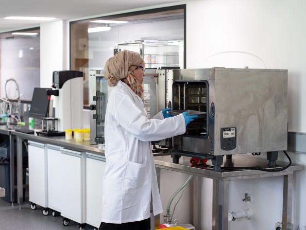 Charlotte Duniam with a commercial oven used in the development of baked and dried products.