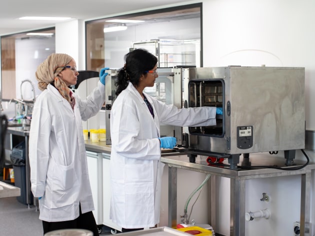 Charlotte Duniam (right) Geethi Eshani Ilukpitiya (left) with a commercial oven used in the development of baked and dried products.