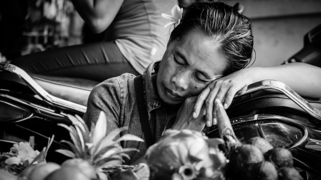 I've shot a lot in the main market in Ubud, Bali, while walking around looking for interesting people and scenes. This lady was taking a nap on one of the many parked motorbikes outside, while also selling produce from a small stall. I included the produce in the scene to give it more context. Fujifilm X-T1, XF18-55mm lens @ 35mm. 1/200s @ f5.6, ISO 200.