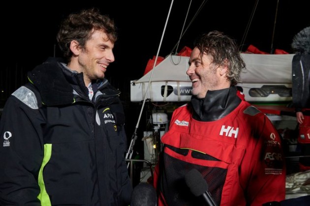 Charlie Dalin (Apivia) and Yannick Bestaven (Maitre Coq) talking on the dock.