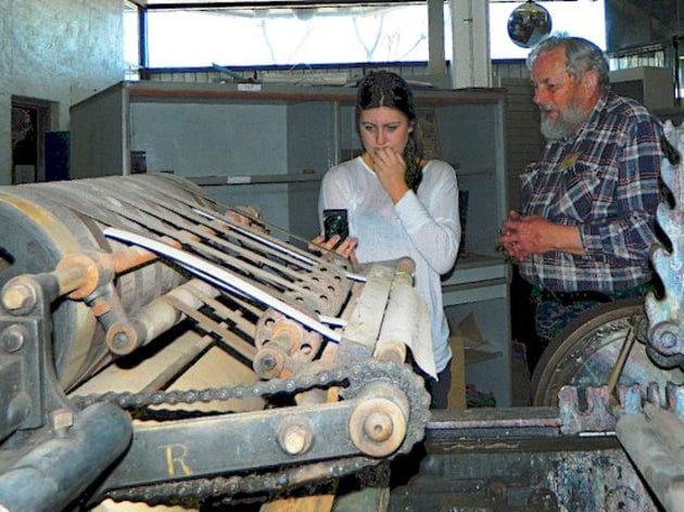 MMoP owner Michael Isaachsen shows a visitor a "stop-cylinder" style press, developed around 1870.