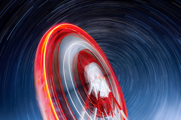 People and Space Runner-up, Rotation © Takanobu Kurosaki (Japan).
In the northern hemisphere, stars appear to rotate around Polaris, which lies near the north celestial pole. This motion, about 15 degrees per hour from east to west, is caused by Earth’s rotation. The giant Ferris wheel at Mirageland in Uozu only operates at night a few times a year, it stands at 66 m (216 ft) high and with a diameter of 62.5 m (205 ft). It takes about 15 minutes for the wheel to make a complete circle.