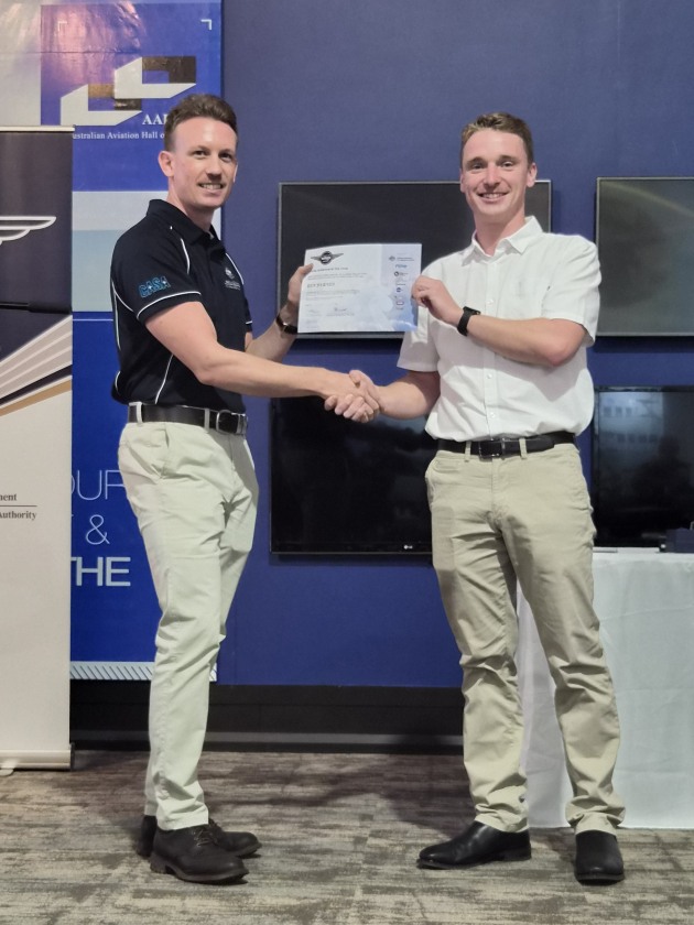 Young Achiever of the Year receives his award from Shaun Holmes