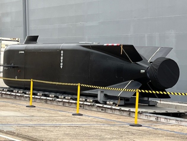 A Ghost Shark extra-large autonomous undersea vessel (XL-AUV) on a Fleet Base East wharf alongside a shipping container and LHD HMAS Adelaide.

Credit: Julian Kerr