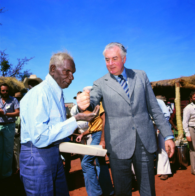 Prime Minister Gough Whitlam pours soil into the hand of traditional landowner Vincent Lingiari in 1975. Mervyn Bishop and DAA filmmaker Terry Horne were on assignment in Brisbane when they received word to get to Wattie Creek for a land handover ceremony involving the prime minister, unaware that Mervyn was about to capture one of the defining images of his career. The famous photograph was actually a redo of the original ceremony, which took place under a shade shelter. The light was dim and the background cluttered, so Mervyn suggested to Whitlam and Lingiari that they step outside. “Would you mind if we do this picture outside, in the bright sunshine?” he asked. They agreed. Using a Hasselblad with Kodak Ektachrome colour slide film and a fill flash to balance the bright light, Mervyn crouched low to include a large sweep of sky. “I imagined using it on the cover of a magazine,” he said. “I wanted to leave room for a masthead, National Geographic or Life, or whatever.”